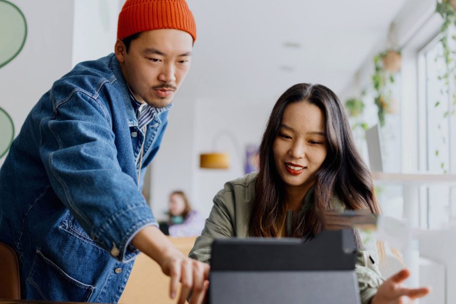 Office workers looking at computer screen