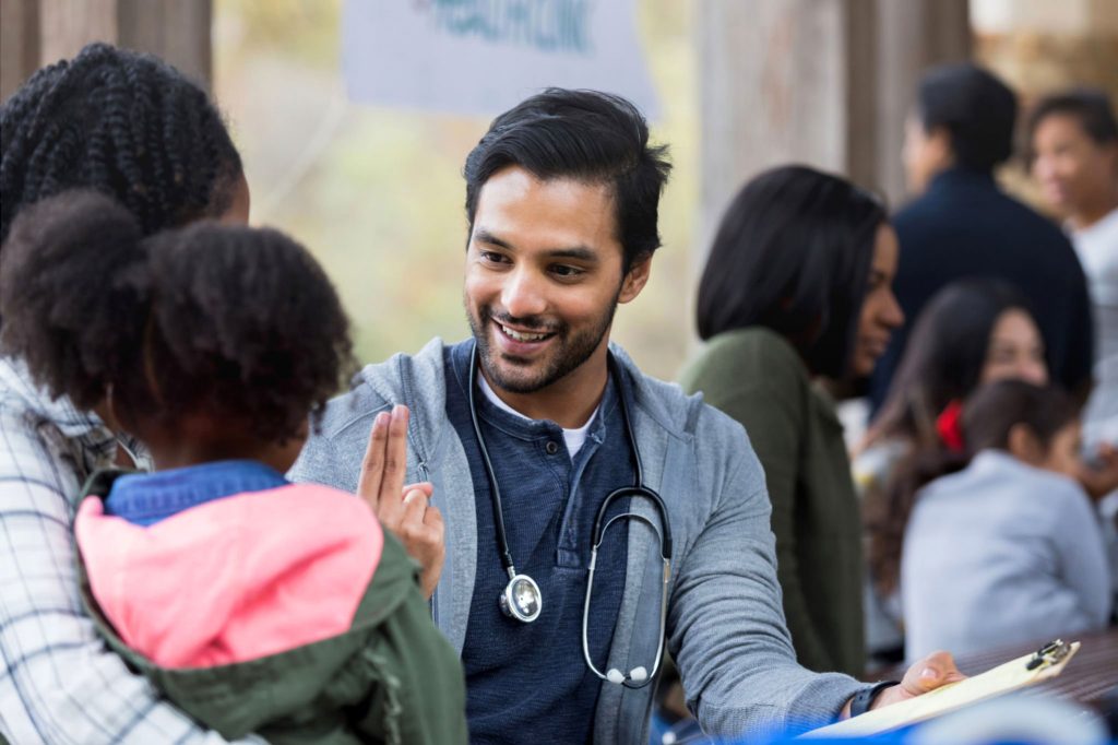 Healthcare worker with parent and child